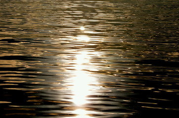 calm golden sunshine reflection on sea surface background