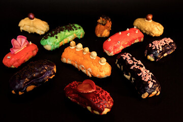 Delicious eclairs on a black background