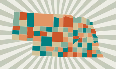 Nebraska map. Poster with map of the US state in retro color palette. Shape of Nebraska with sunburst rays background. Vector illustration.