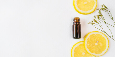 Bottle of lemon essential oil on white background for beauty, skin care, wellness and medicinal...