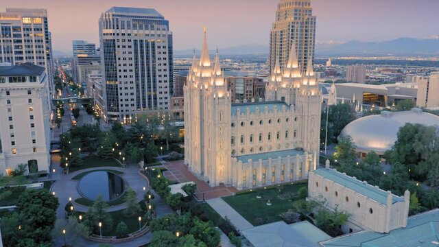 Aerial: Flying over the Salt Lake Temple in Temple Square. Downtown Salt Lake City at night. Utah, USA