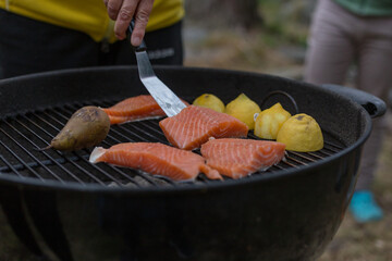 Preparing salmon and lemons on the grill