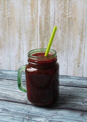 Berry smoothie in a green glass mug with a straw. The concept of a healthy diet and lifestyle, healthy Breakfast.
