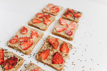 toast bread with peanut paste and strawberries