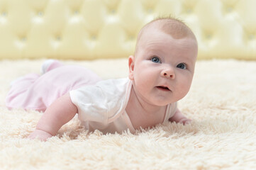 Portrait of funny little baby girl crawling