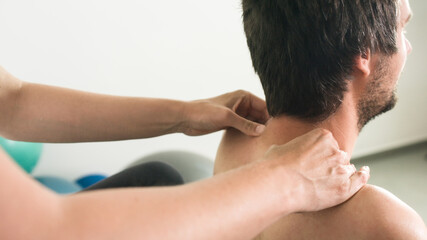 Obraz premium Physiotherapist doing massage and stretching with person on a therapy table.