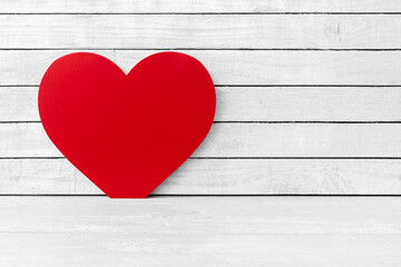 Red Heart Shaped on white wood over white wood background
