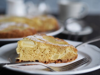 Home cooking.Sponge cake with pineapple on a dark background.