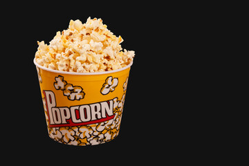 bucket of popcorn on black background