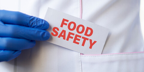 Doctor holding a card with text Food Safety, medical concept