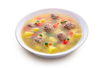 Meatballs with green peas in the potato soup