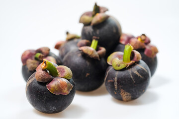 mangosteen fruits placed on a white background