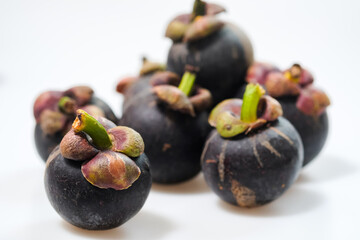 mangosteen fruits placed on a white background