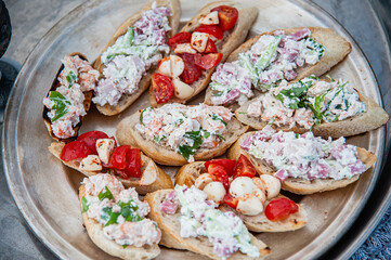 Sandwiches with tomato and shrimp salad on a metal plate. Closeup