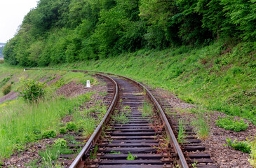 Railroad with wooden sleepers in the forest
