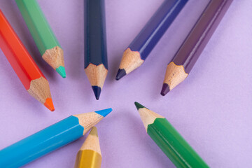 Color pencils close-up on color and white paper