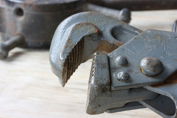 Pipe lever wrench in gray on a tool background