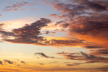 Obraz premium Dramatic sunset sky with orange clouds. Golden clouds in the sky.