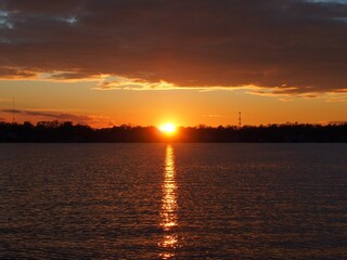 Michigan boaters enjoying a peaceful sunset on Lake Lansing in Haslett, Mi