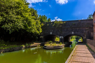 A view of a bridge carrying the Birmingham canal over the Dudley canal in summertime