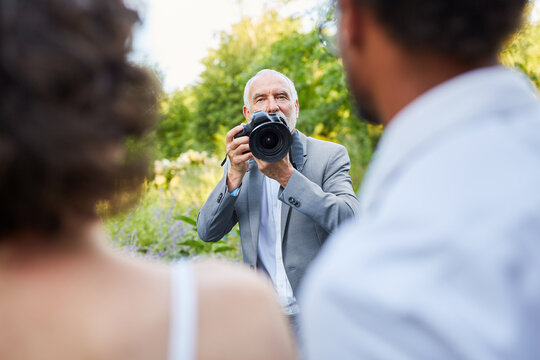 Hochzeitsfotograf und Brautpaar beim Fotoshooting