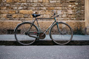 Fototapeta na wymiar Old retro bike against the background of the old brick wall
