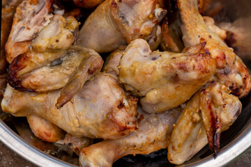 Appetizing grilled chicken legs and wings. Close-up.