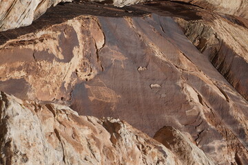 Ancient Petroglyphs carved into a rock climbing crag in Indian Creek, Utah.