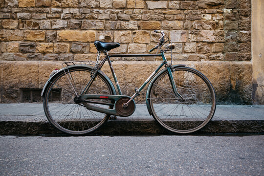 Old retro bike against the background of the old brick wall