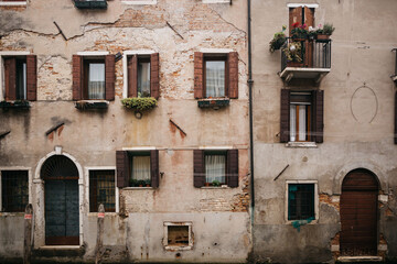 A very old building in Europe with windows, a balcony and doors. Beautiful wall for the background. 