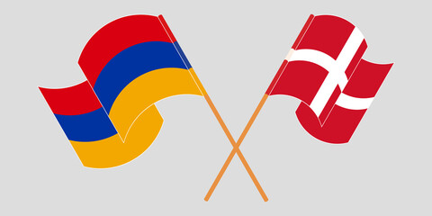 Crossed and waving flags of Armenia and Denmark