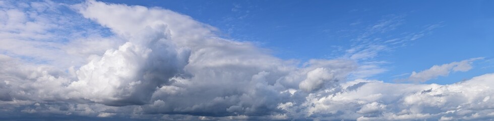 September is the autumn sky.
Panoramic photo of dense clouds flying low above the ground.