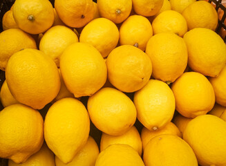 Organic Lemons In Supermarket. Yellow Citrus Fruit Lemon background.