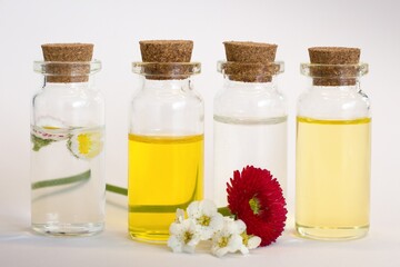 Beautiful photo of small bottles with cork stoppers filled with fantastic fragrant oils, essential...
