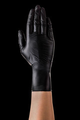 Hand in black gloves showing five fingers and palm isolated on black background