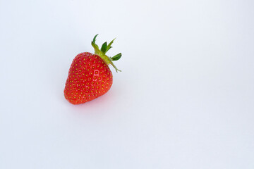 one red strawberry against white background