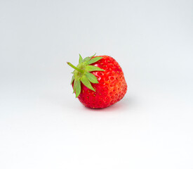 one red strawberry against white background