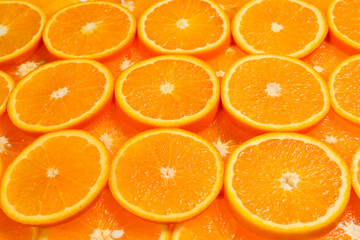 Slices of oranges as a background, top view.