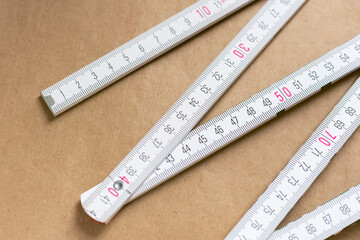 folding ruler measuring tool on a brown background. Kraft paper background