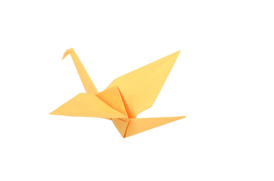 A yellow origami bird on white background