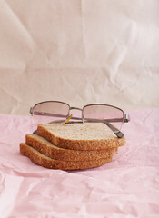 
Glasses lie on bread on a paper background