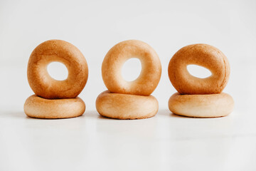 Drying or mini round bagels on a white wooden background. Copy, empty space for text