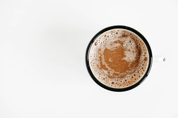 Metal mug with hot coffee on a white wooden background. Top view. Copy, empty space for text