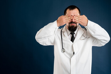 Male doctor with stethoscope in medical uniform covering eye like blind concept