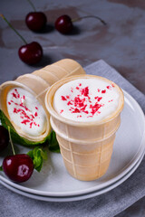 Creamy ice cream topped with sublimated berry powder in waffle cup cones
