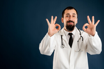 Male doctor with stethoscope in medical uniform showing double OK sign