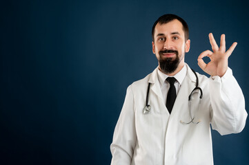 Male doctor with stethoscope in medical uniform showing OK sign