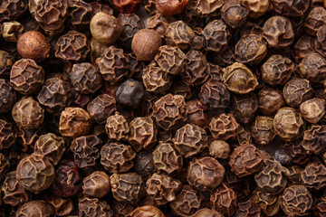 Top view of pile of black peppercorns, close up.