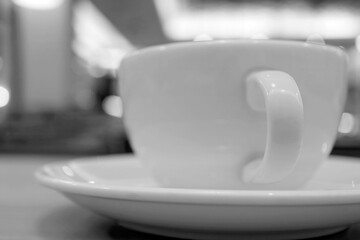 Closeup a cup of coffee on the table in monotone