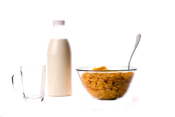 cereal in a bowl with a bottle of milk and a mug